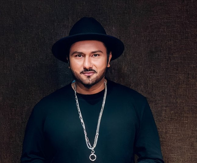 A portrait with a black hat and silver chain.